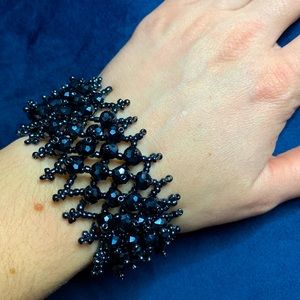 Shiny dark gray/metallic look beads bracelet.